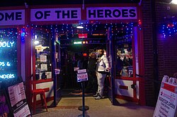 A bouncer guards the entrance to one of the many honky-tonk bars in Nashville's nightlife district, Broadway.