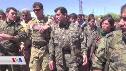 A Delta Force officer and YPG and YPJ commanders tour an area hit by Turkish airstrikes in April 2017