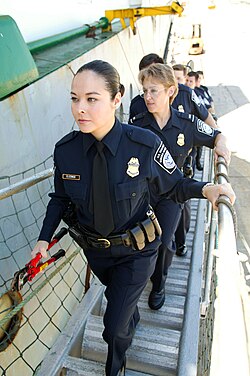 US customs and border officers boarding a ship at the border.