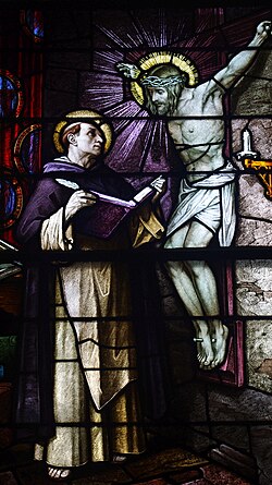 An icon of the crucifixion speaking to Thomas Aquinas is depicted on this stained glass window in Saint Patrick Church in Columbus, Ohio.