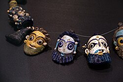 Phoenician faces. Glass from Olbia, 4th century BC. The bold pools of color and detailed hair give a Greek impression.