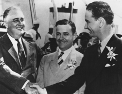 Johnson (right) with President Franklin D. Roosevelt (left) and Texas governor James Burr V Allred (center) in 1937; he later used an edited version of this photo with Allred airbrushed out in his 1941 senatorial campaign.[30]