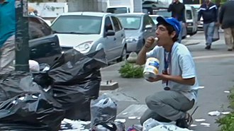A Venezuelan eating from garbage during the crisis in Bolivarian Venezuela