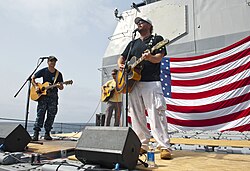 Country singer Toby Keith performing for US Navy personnel on the USS Cape St. George