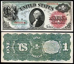 Reverse side (lower) of $1 United States note, 1869 series ("greenback"), showing "US" ≈ '$' monogram.