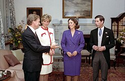 The Waleses and Quayles converse while standing.