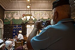 Syrian Jews worship in Ades Synagogue. Renowned as a center for Syrian Hazzanut (Syrian Jewish liturgical singing), Ades is one of only two synagogues in the world that maintains the ancient Syrian Jewish tradition of Baqashot, the marathon Kabbalistic singing held in the early hours of Shabbat morning to welcome the sunrise over winter months.