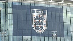 Logo of the governing body of English football, the FA, as displayed on the exterior of Wembley Stadium