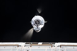 Cargo Dragon fires its Draco engines as it approaches during CRS SpX-33