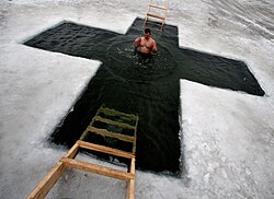 An ice hole is cut in the form of a cross in Russia to celebrate the Epiphany.