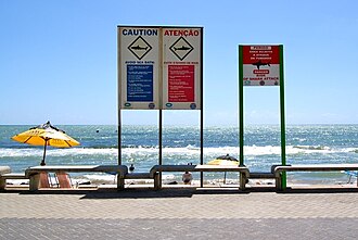 Signs warning of shark attacks at Boa Viagem Beach.