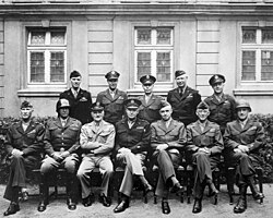 Senior American commanders of the European theater of World War II. Seated, from left to right, are William H. Simpson, George S. Patton, Carl A. Spaatz, Dwight D. Eisenhower, Omar Bradley, Courtney Hodges, and Leonard T. Gerow; standing are (from left to right) Ralph F. Stearley, Hoyt Vandenberg, Walter Bedell Smith, Otto P. Weyland, and Richard E. Nugent.