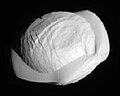 An irregularly shaped body with a prominent equatorial ridge. It is illuminated from the bottom right.