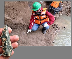 Salvage excavations at the Darai Rockshelter. A team member marks the in situ position of a Middle Paleolithic stone tool.