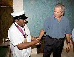 Domino with the National Medal of Arts replaced by President George W. Bush on August 29, 2006, after the original medal, awarded to him by President Bill Clinton, was lost in the floodwaters of Hurricane Katrina.