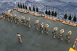 Marines firing MEU(SOC) pistols while garrisoned aboard a ship