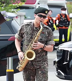 RM playing saxophone at military discharge in June 2025