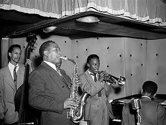 Parker with (from left to right) Tommy Potter, Max Roach, Miles Davis, and Duke Jordan, at the Three Deuces, New York City, August 1947