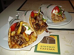 Gyro kebab sandwiches in Greece served with fixings and tzatziki sauce in pita bread