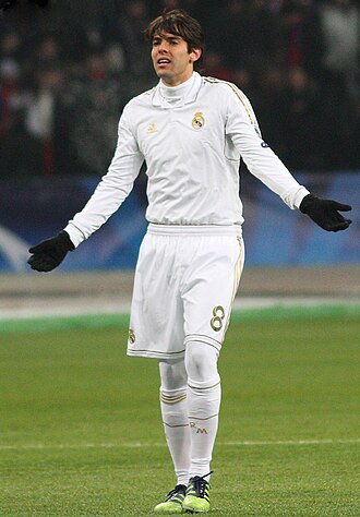 Kaká wearing the Real Madrid CF home kit at a UEFA Champions League match in 2012. In addition to the mandatory shirt with sleeves, shorts, socks, shinguards (covered by socks) and boots as stipulated by Law 4.2, he is also wearing optional gloves and thermal base layers which are permitted under Laws 4.4 and 4.3 respectively.