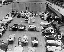 American Red Cross nurses tend to flu patients in temporary wards set up inside the Oakland Municipal Auditorium