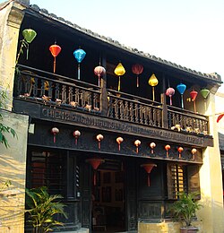 Two-story wooden house with balcony.