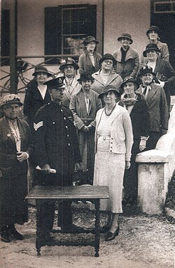 A Police Sergeant confiscates women's suffrage activist Gladys Morrell's table in the 1930s