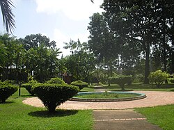 Botanical garden of Cayenne, with a statue of Gaston Monnerville statue at its center.