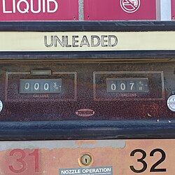 A fuel pump with a rotary accumulator, above which is "unleaded" in block capitals.