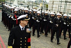 The dark blue Number 1A uniform worn with pith helmets