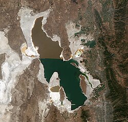 Satellite photo of the Great Salt Lake in Utah, U.S.A., from August 2018 showing a major color difference between the northern and southern portions of the lake as a result of a mineral imbalance caused by the Lucin Cutoff.
