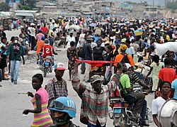 A street scene of Port-au-Princiens with a UN Peacekeeper of the Haiti mission