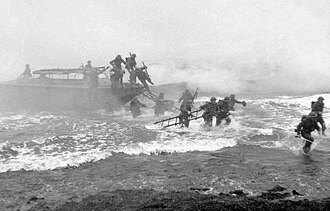 British Major Jack Churchill (far right) leads commandos during a training exercise, sword in hand, in World War II.