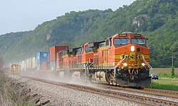 An eastbound BNSF Railway train passes some maintenance of way equipment in Prairie du Chien, Wisconsin, August 8, 2004. The lead unit is painted in the Heritage II scheme.