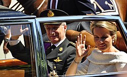 King Philippe and Queen Mathilde wave to the crowds in Brussels after Philippe's swearing in as the new Belgian monarch, 21 July 2013.