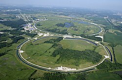 Bird's-eye view of a large circular shape inscribed into a grassy area