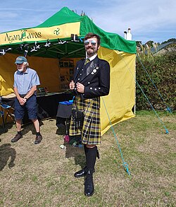 A man wearing Cornish tartan on Gorsedh Day 2025 at Marazion, Cornwall.