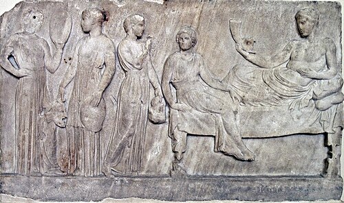 Relief, now in Athens, showing Dionysus with actresses (possibly from The Bacchae) carrying masks and drums