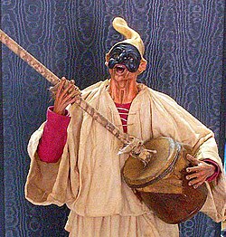 The Neapolitan folk-figure, Pulcinella, playing the putipù.