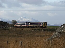 The line near Duirinish station; the Isle of Skye can be seen in the background with a covering of snow.