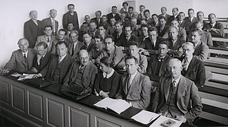 At a conference in 1937, Meitner shares the front row with (left to right) Niels Bohr, Werner Heisenberg, Wolfgang Pauli, Otto Stern, Rudolf Ladenburg and Jacob Christian Georg Jacobsen; Hilde Levi (at the very back) is the only other woman in the room.
