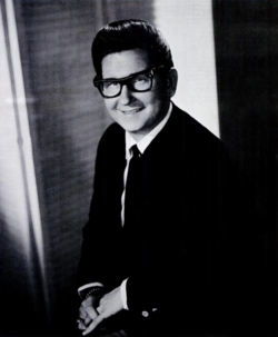 Orbison in 1965, wearing thick-rimmed glasses