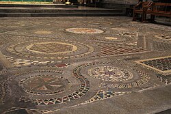 The Cosmati pavement: an elaborately-patterned floor with geometric designs with small red, brown, black and gold tiles