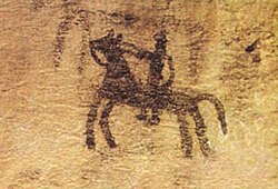 Prehistoric cave painting, depicting a horse and rider