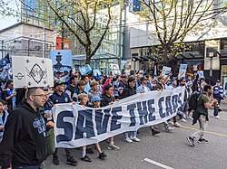 Supporters marching on Robson Street in April 2026 for "Save The Caps" as the teams future in Vancouver is uncertain.