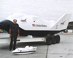 Dale Reed with the X-38 and a subscale model used in the test program.