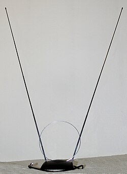 Indoor rabbit ears antenna often used for terrestrial television reception. This model also has a loop antenna for UHF reception.