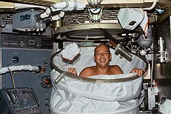 NASA astronaut Pete Conrad taking a shower aboard the Skylab space station.