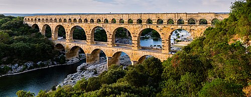 A stone arch bridge passing over a river valley