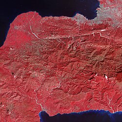 Tiny dots of white against the plant-covered landscape (red in this image) are possible landslides, a common occurrence in mountainous terrain after large earthquakes. The Enriquillo-Plantain Garden fault zone runs along the two linear valleys at the top of the image.